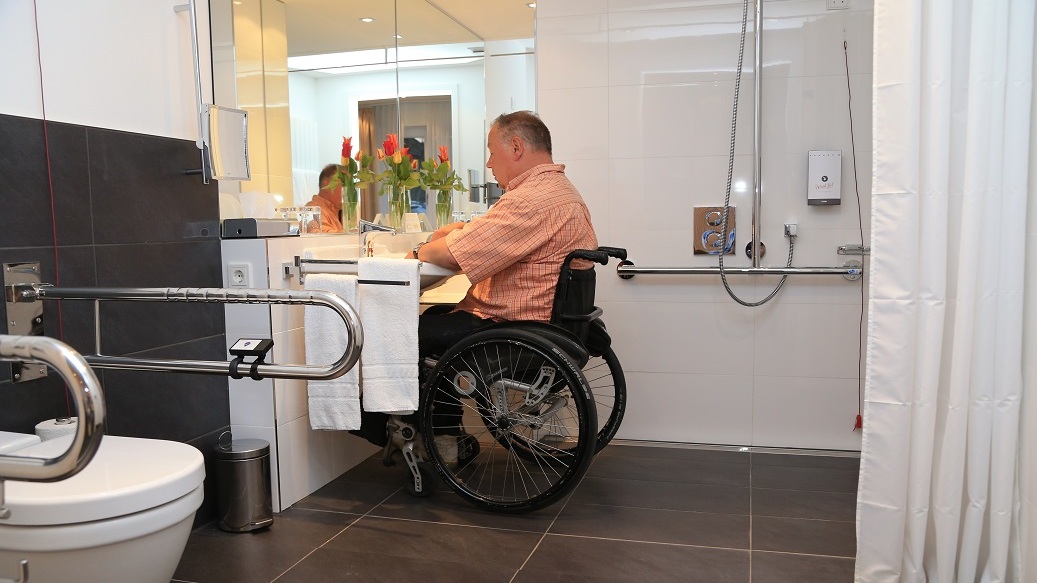 Accessible bathroom with wheelchair accessible vanity and lots of space